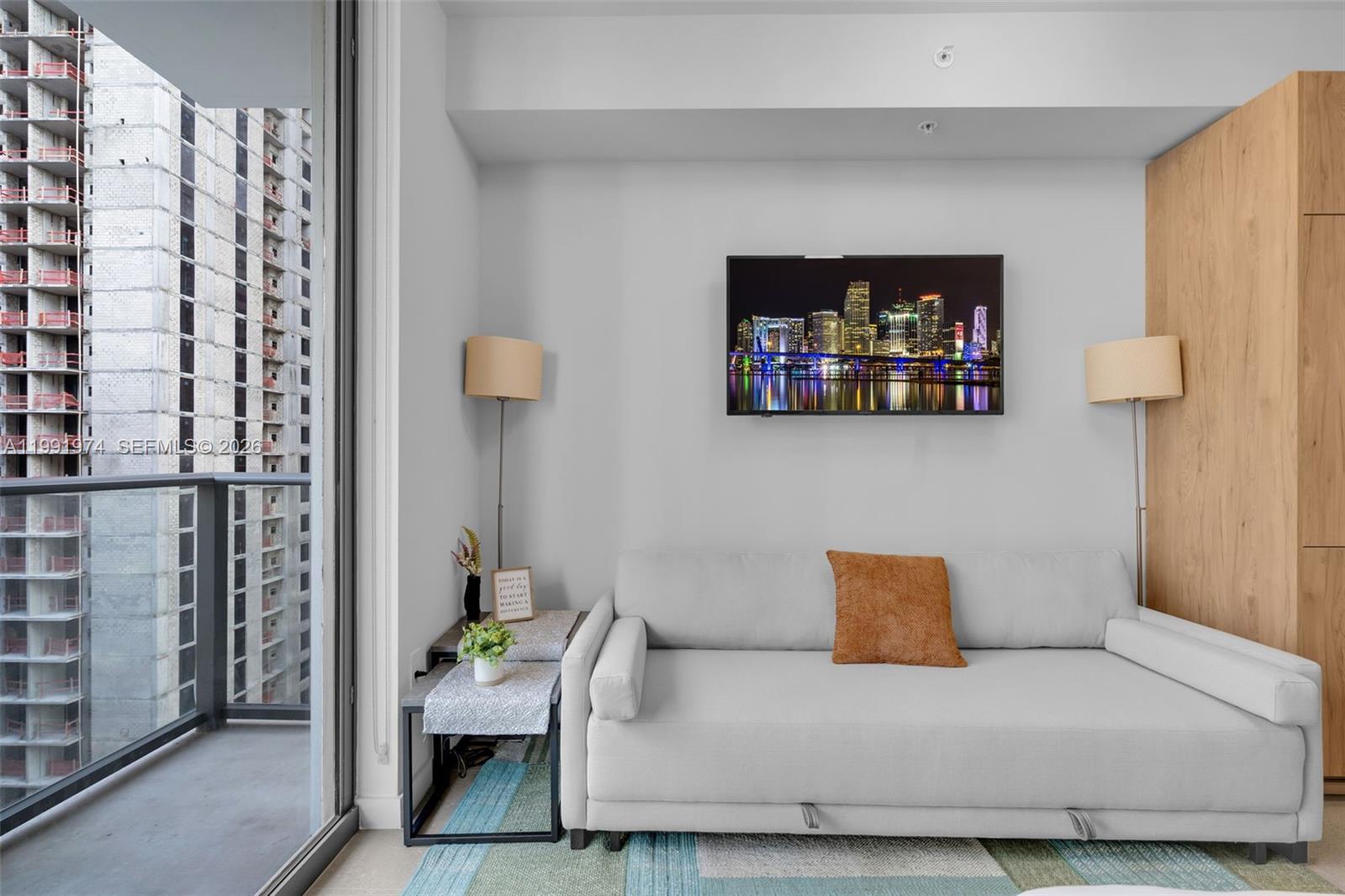 11 Northeast 6th Street, Unit 2808 Miami, FL 33132 - Photo 13 of 57 a living room with furniture and a painting on the wall