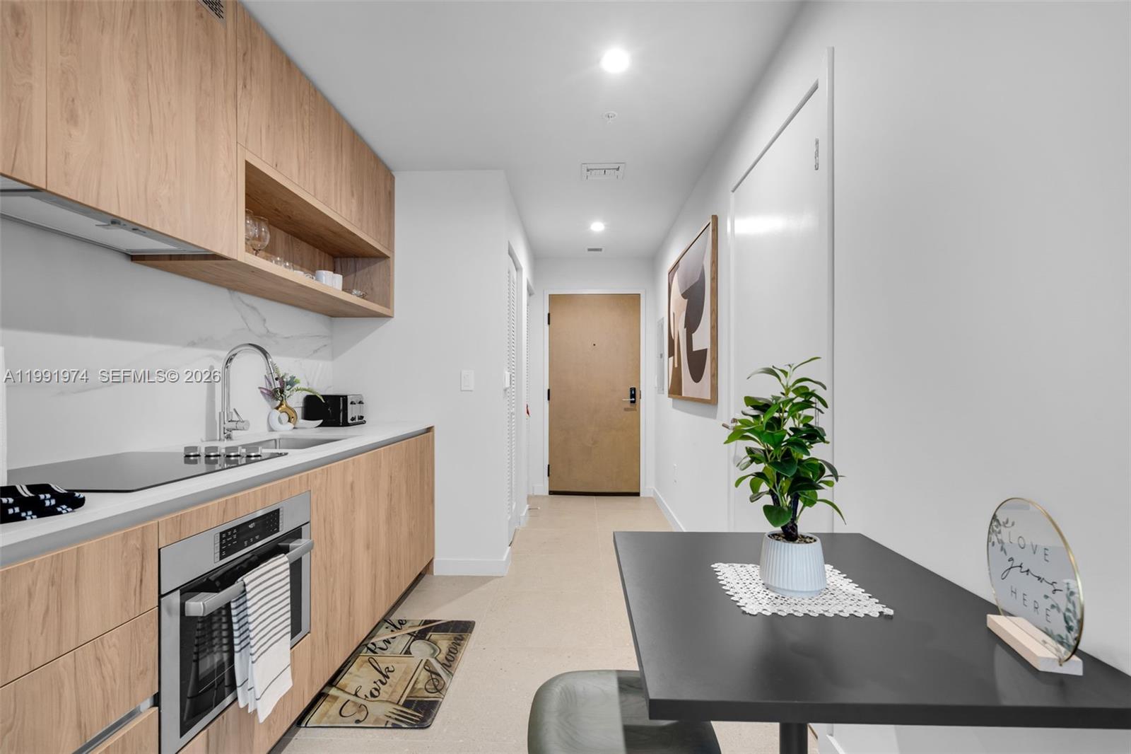 11 Northeast 6th Street, Unit 2808 Miami, FL 33132 - Photo 3 of 57 a kitchen with a table and chairs