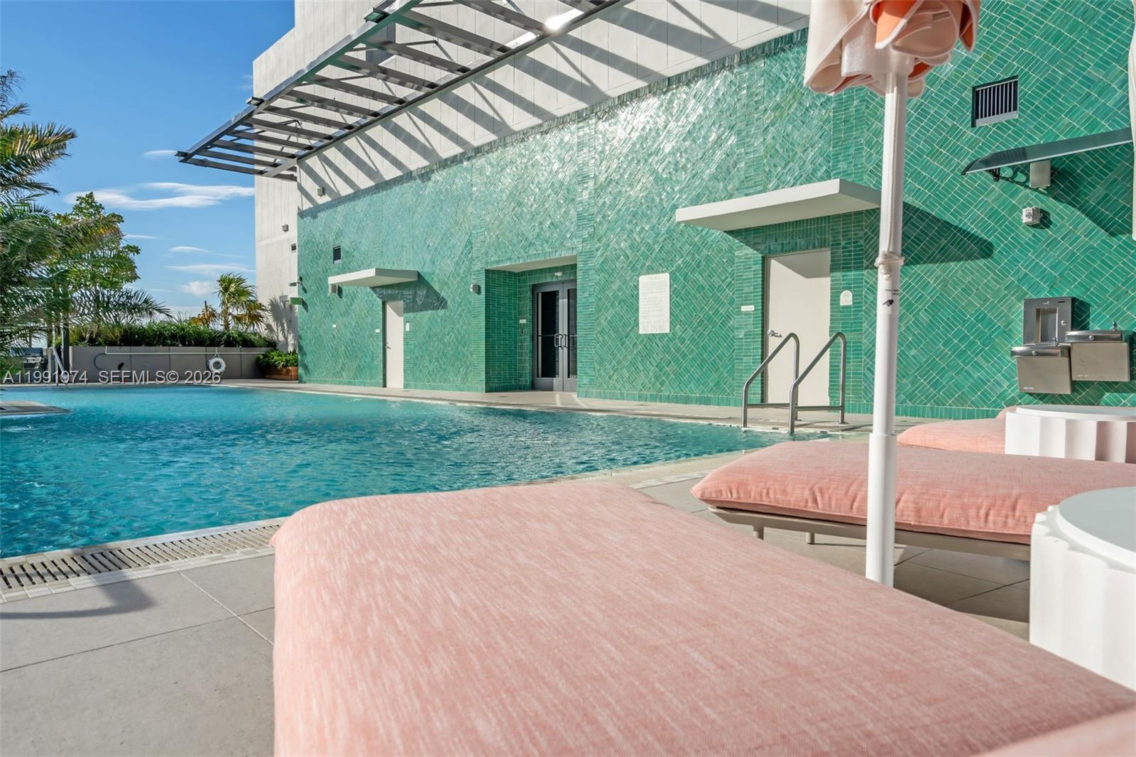 11 Northeast 6th Street, Unit 2808 Miami, FL 33132 - Photo 39 of 57 a view of a backyard with table and chairs under an umbrella