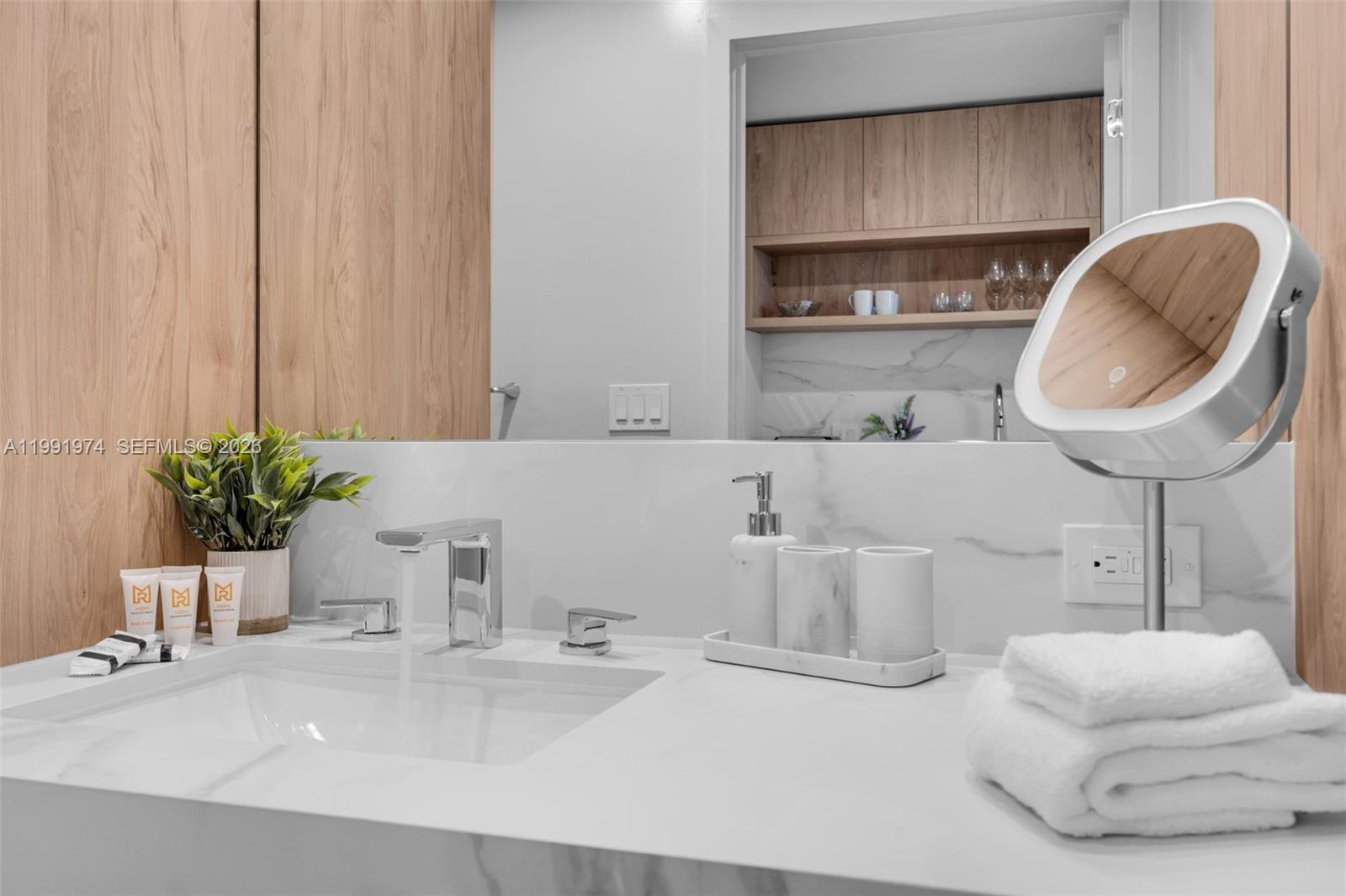 11 Northeast 6th Street, Unit 2808 Miami, FL 33132 - Photo 7 of 57 a bathroom with a double vanity sink a mirror and bathtub