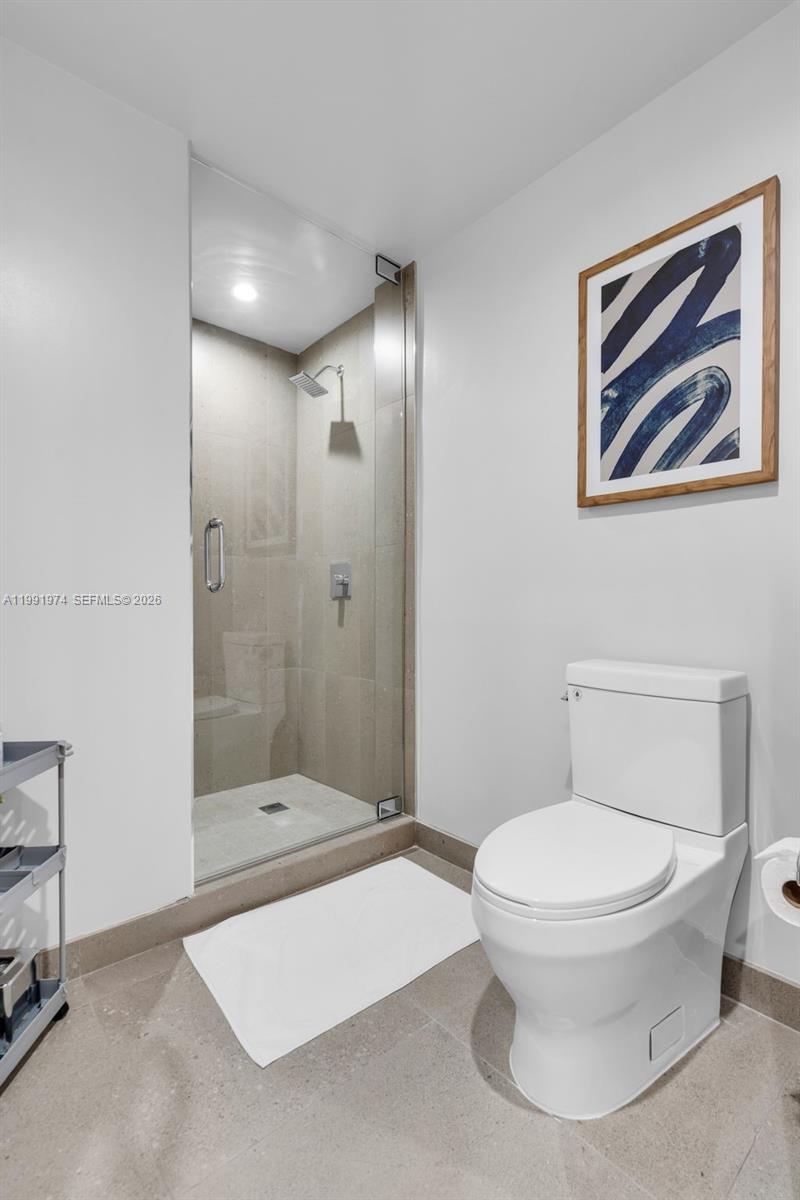 11 Northeast 6th Street, Unit 2808 Miami, FL 33132 - Photo 8 of 57 a bathroom with a toilet sink and shower