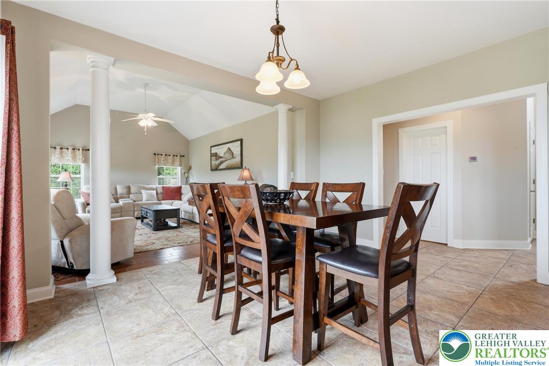 245 East Dell Road Bath, PA 18014 - Photo 21 of 99 An inviting dining area flows seamlessly into the main living space, highlighted by soaring vaulted ceilings.