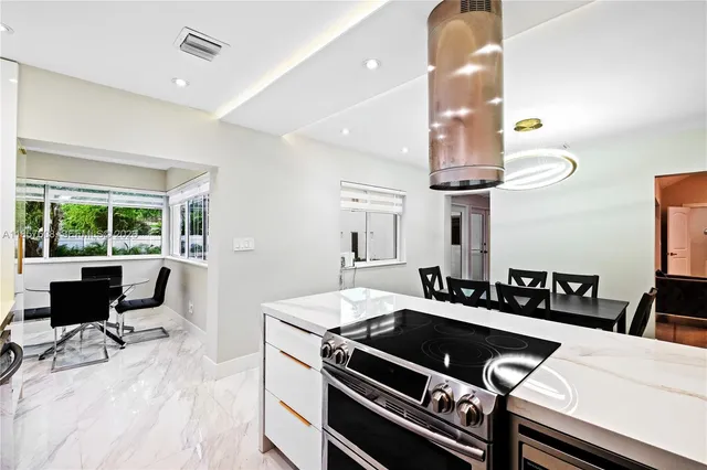 a kitchen with stainless steel appliances a refrigerator sink and cabinets