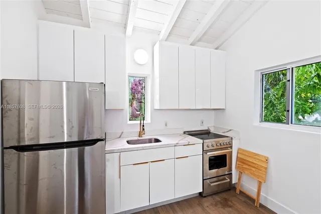 a bedroom with a bed lamp and a window