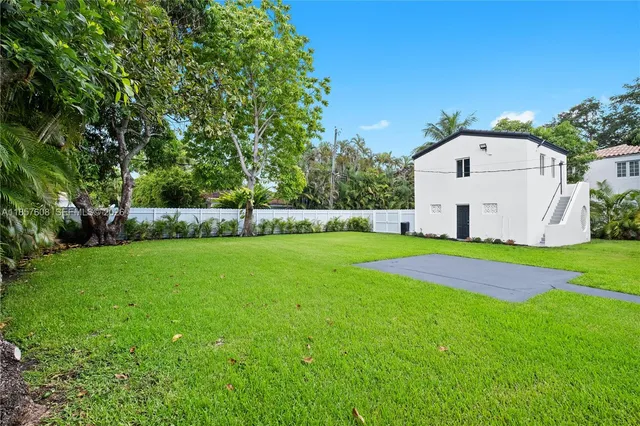 a view of backyard with swimming pool