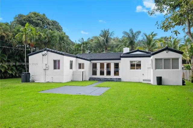 an aerial view of a house with garden space and street view