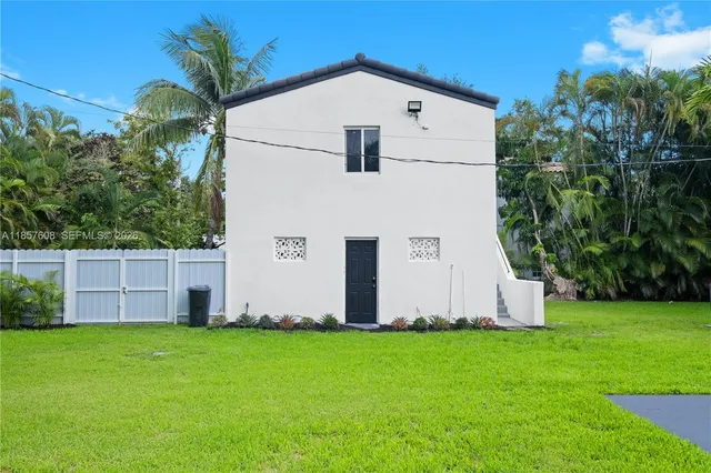 an aerial view of a house with a yard and a garden