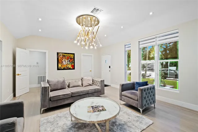 a bedroom with two beds and wooden floor