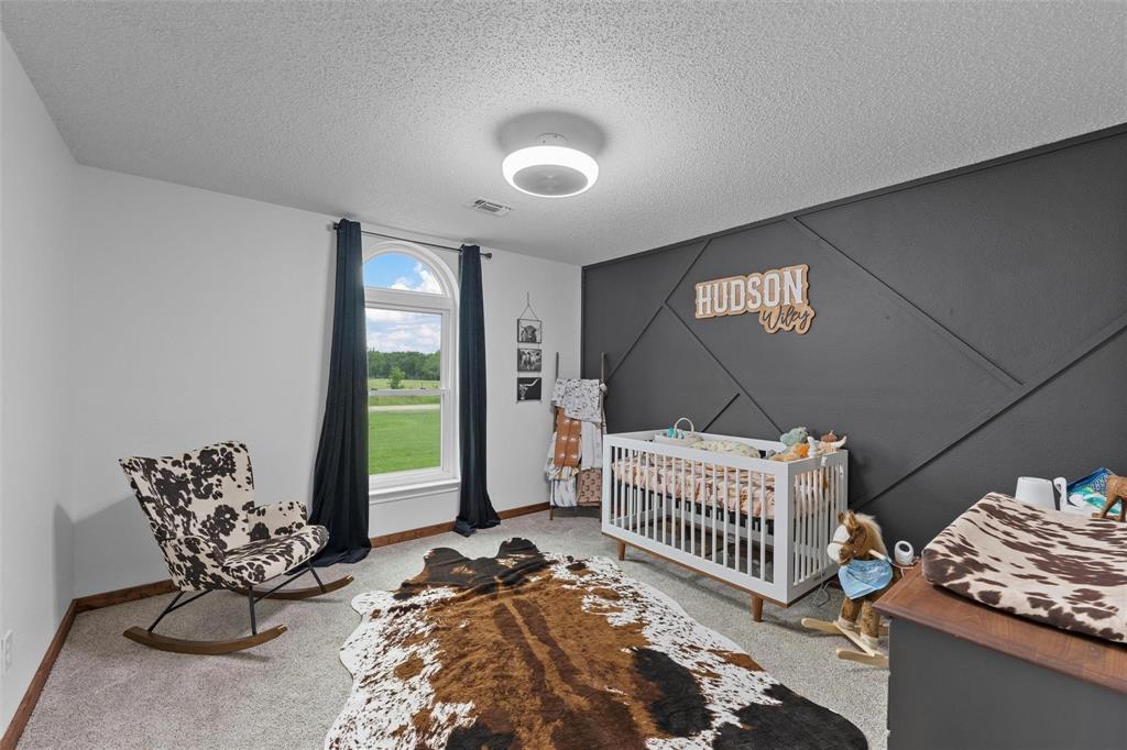 104 Oak Hill Loop Whitney, TX 76692 - Photo 2 of 2 a bedroom with furniture and a window