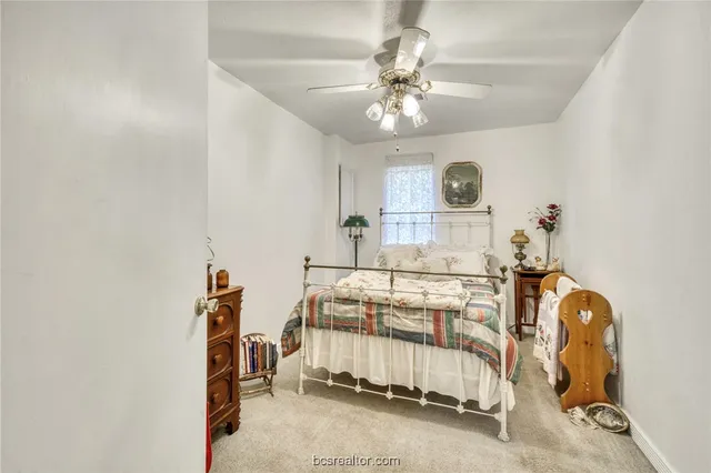 a living room with furniture a flat screen tv and a floor to ceiling window