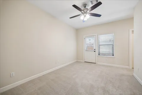 an empty room with closet and windows
