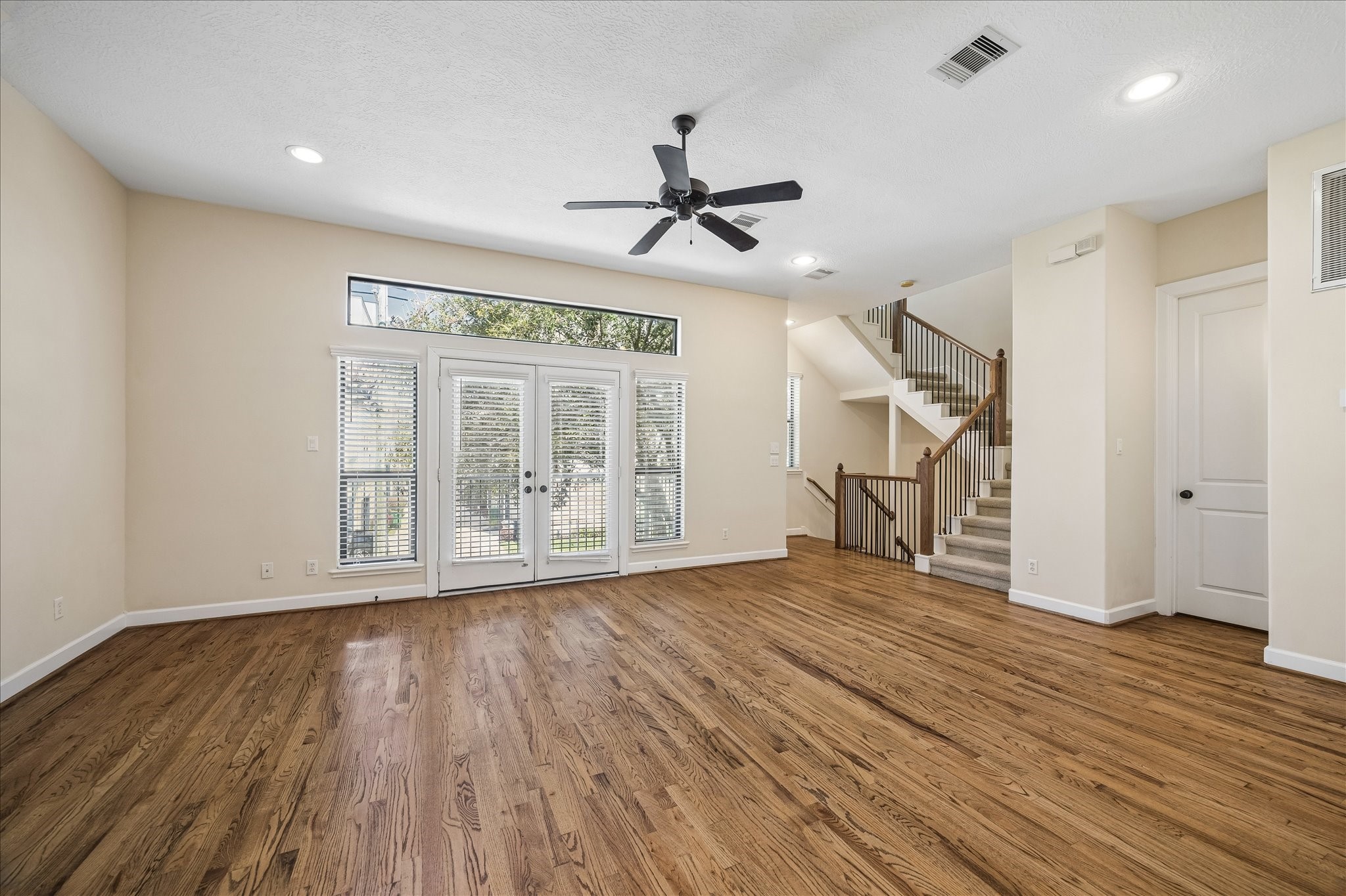 5811 Maxie Street Houston, TX 77007 - Photo 18 of 19 a view of empty room with wooden floor and fan