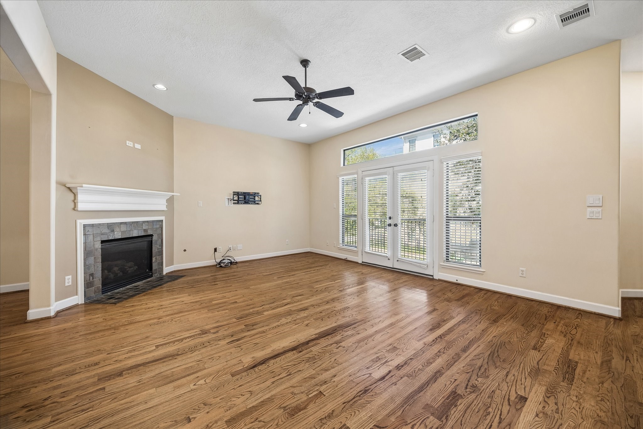 5811 Maxie Street Houston, TX 77007 - Photo 2 of 19 a view of an empty room with wooden floor and a window