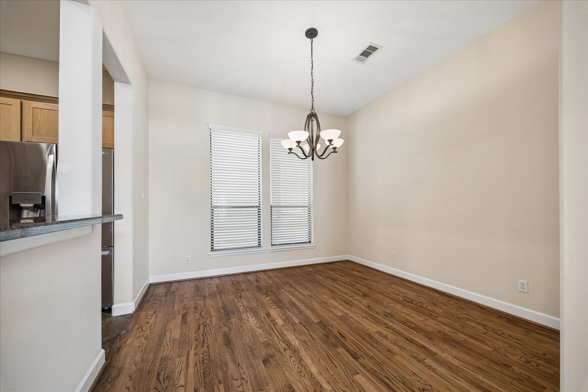 5811 Maxie Street Houston, TX 77007 - Photo 6 of 19 a view of an empty room with wooden floor and a window