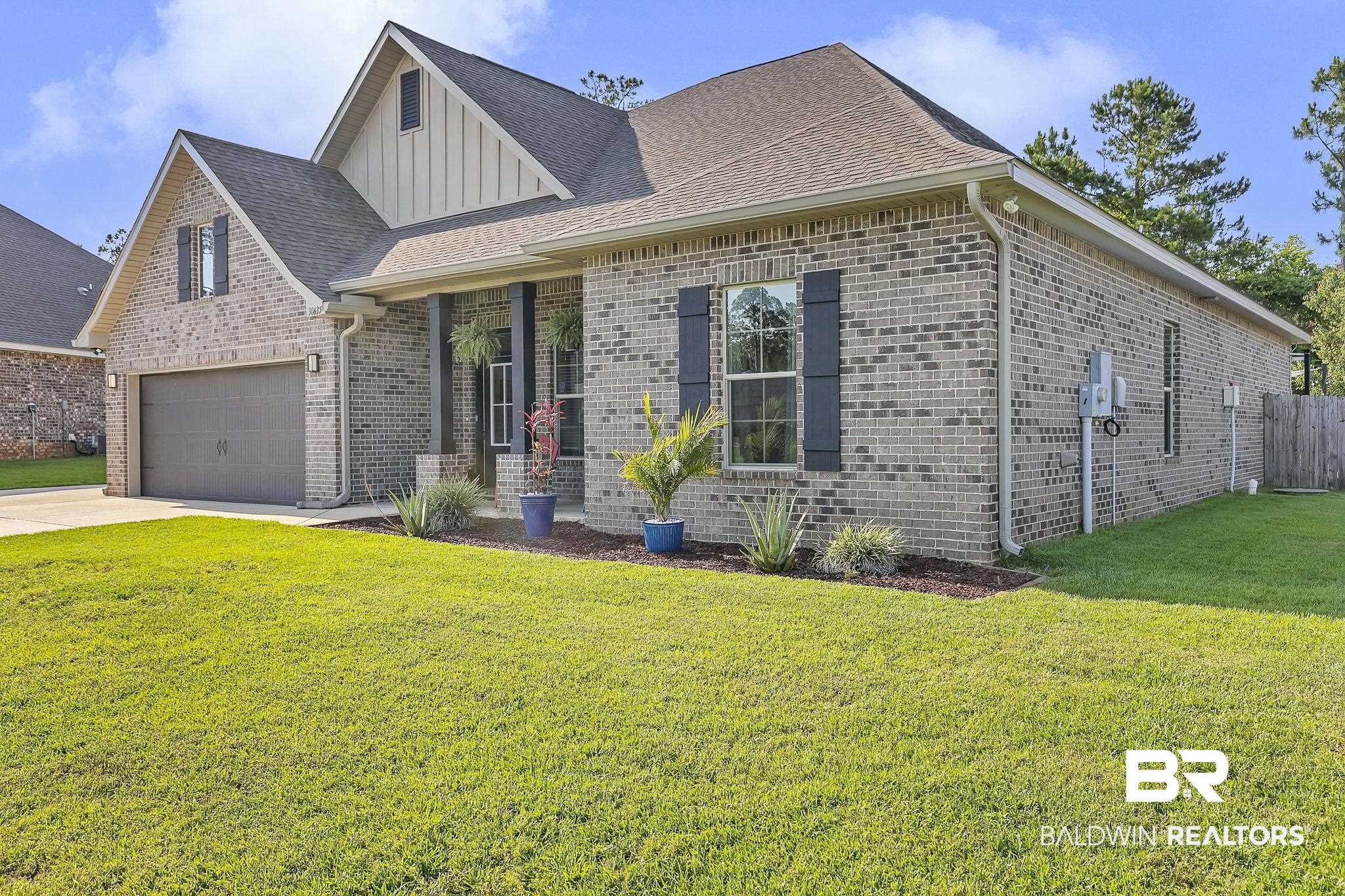 30635 Drayton Court Daphne, AL 36527 - Photo 5 of 51 View of front of property with board and batten siding, brick siding, a garage, driveway, and a shingled roof