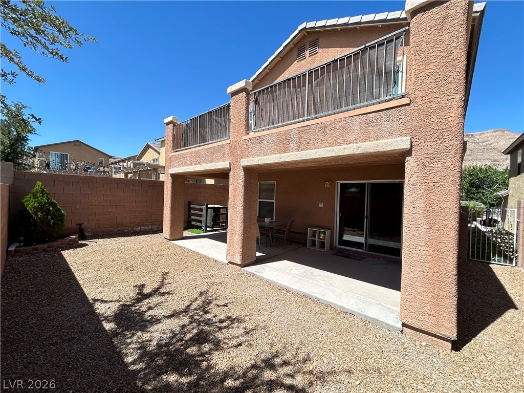 6538 Elm Spring Las Vegas, NV 89148 - Photo 25 of 29 A spacious backyard with a private patio and balcony provides generous outdoor living opportunities.