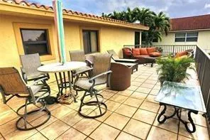 a outdoor space with a table and chairs