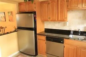 a kitchen with a refrigerator and cabinets