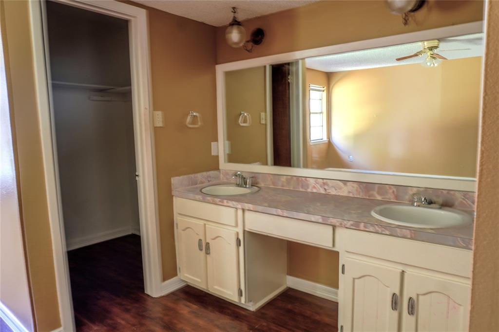 300 Coury Road Everman, TX 76140 - Photo 13 of 29 a bathroom with a granite countertop sink and a mirror