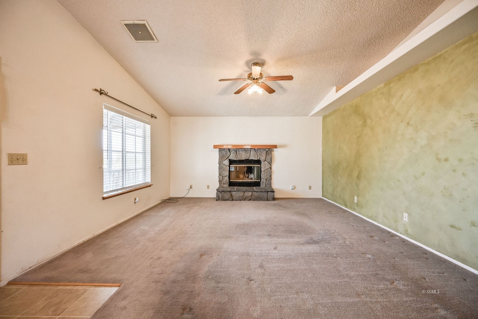 401 North Inyo Street Ridgecrest, CA 93555 - Photo 8 of 37 a view of an empty room with a fireplace and a window