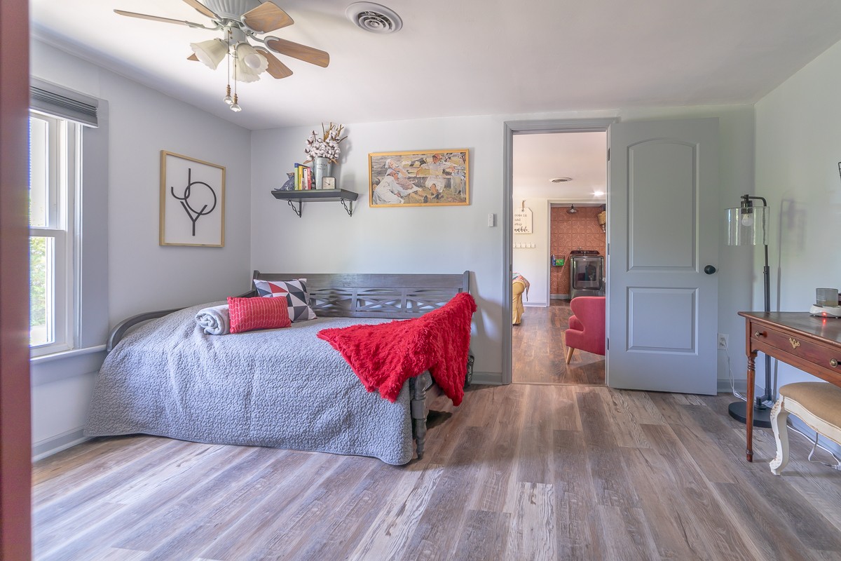 409 South 11th Street Clarksville, TN 37040 - Photo 14 of 29 a bedroom with a bed and a chandelier