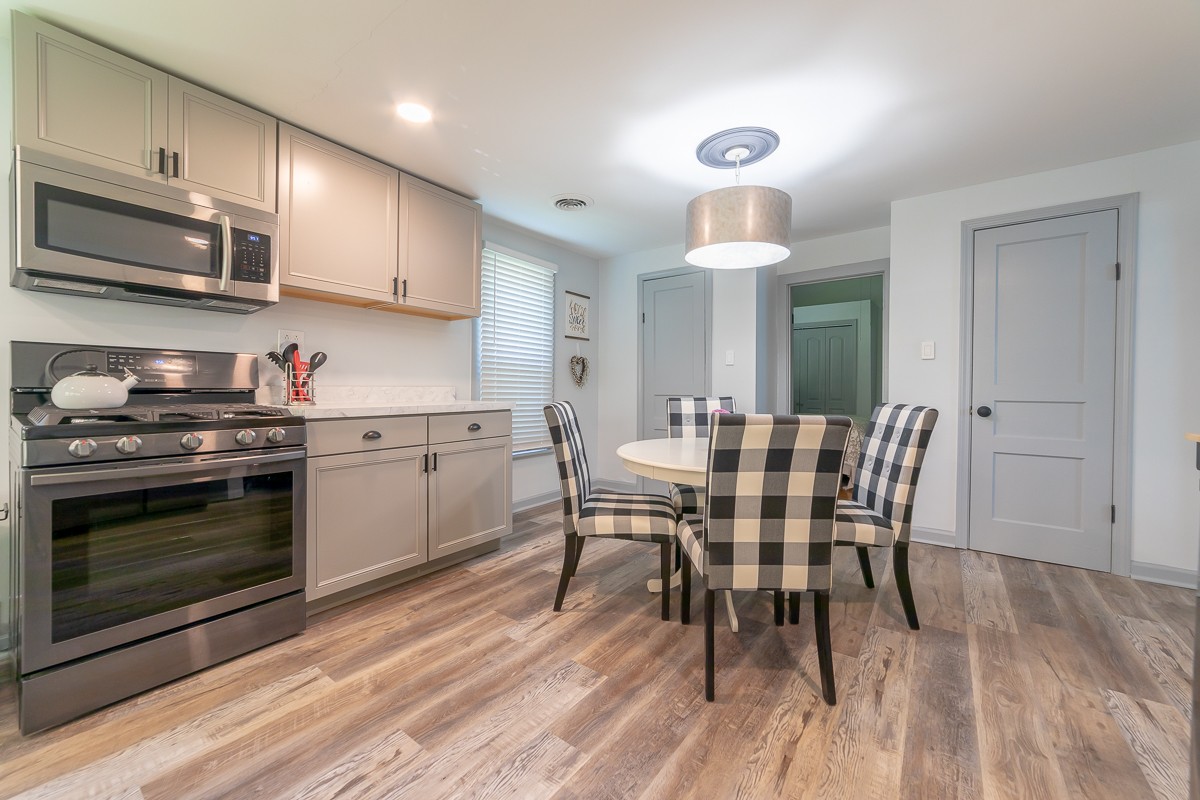 409 South 11th Street Clarksville, TN 37040 - Photo 8 of 29 a kitchen with a table chairs microwave and cabinets
