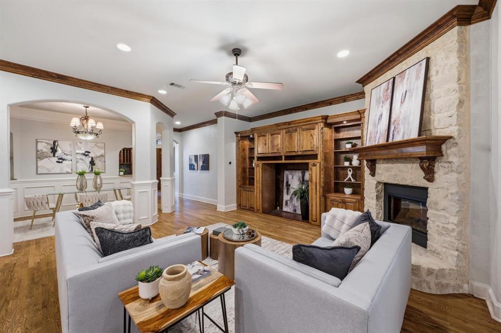 620 Highview Lane Hurst, TX 76054 - Photo 12 of 40 Living area featuring wood-finish flooring and a stone-clad fireplace with a decorative wood mantel