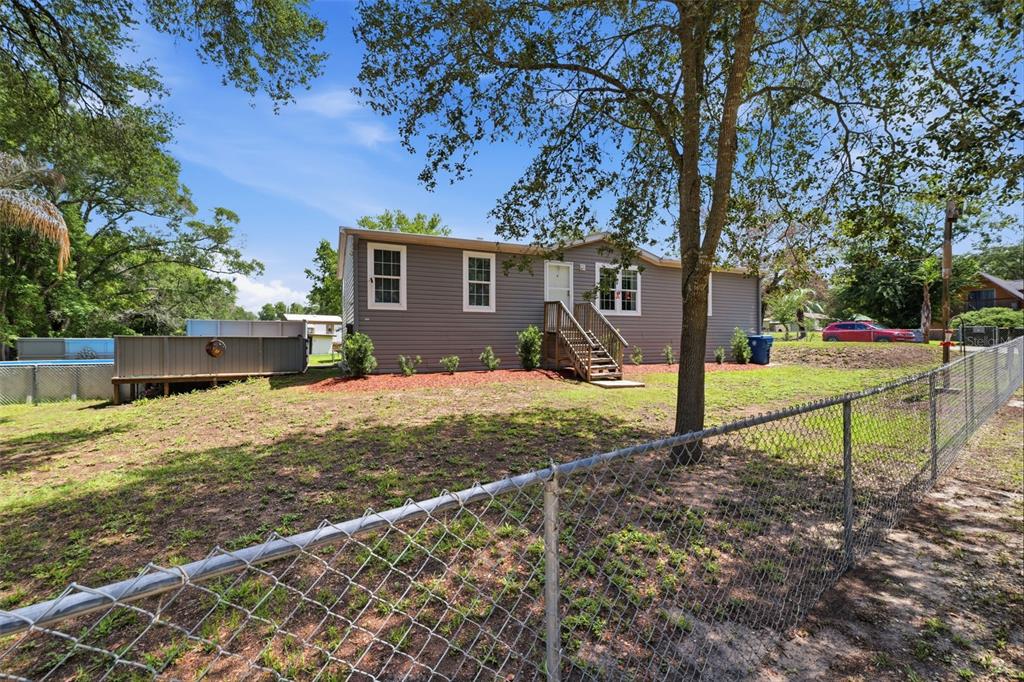 3183 Cedley Road Dade City, FL 33523 - Photo 5 of 48 a house view with a backyard space