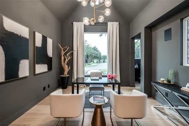 a dining room with furniture a chandelier and window