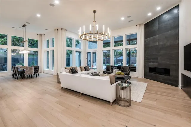 a view of a dining room with furniture large windows and wooden floor