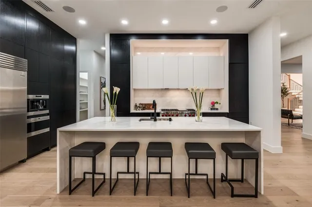a kitchen with cabinets and chairs