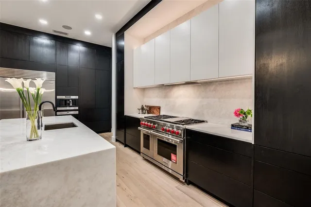 a kitchen with stainless steel appliances granite countertop a sink stove and refrigerator