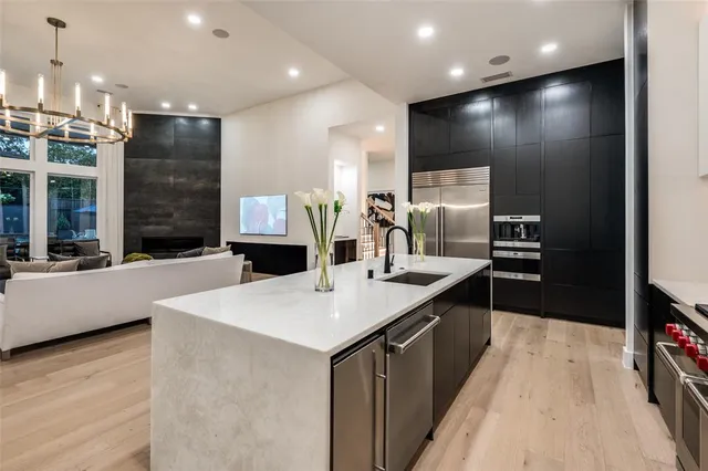 a kitchen with kitchen island a sink appliances and a counter top space