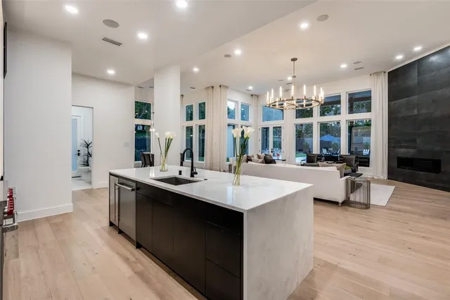 a large kitchen with stainless steel appliances a large island in the center