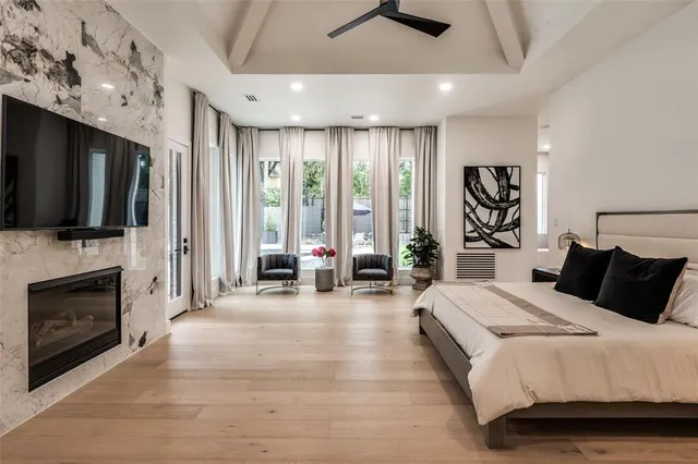 a bedroom with a bed couch and a flat tv screen