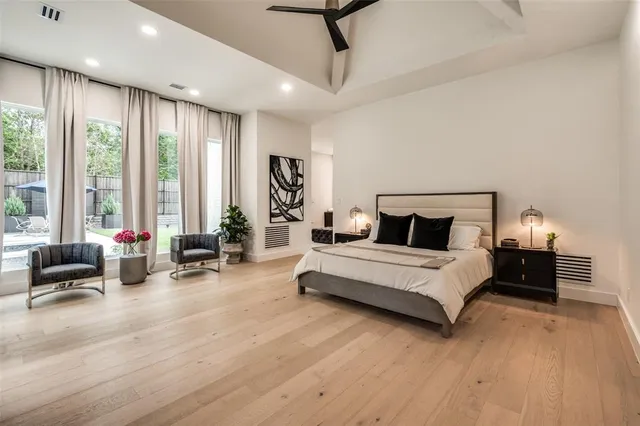 a spacious bedroom with a bed and large windows