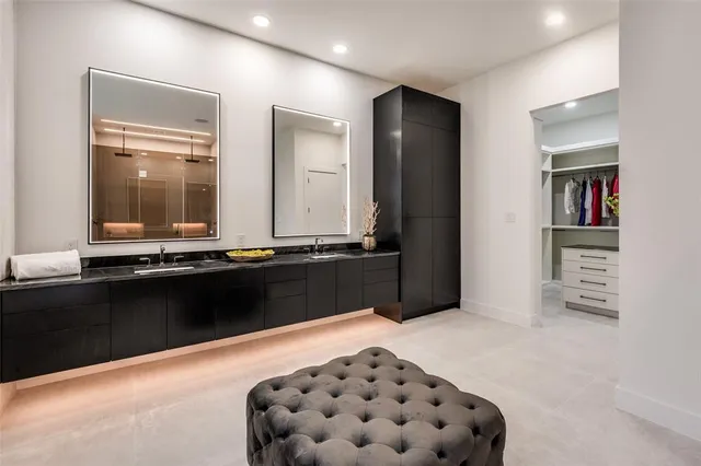 a bedroom with a bed and a large mirror