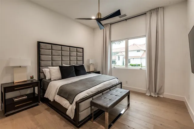 a bed sitting in a bedroom next to a window