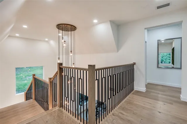 a view of a hallway with wooden floor and entryway