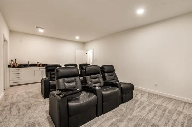 a media room with lots of chairs and wooden floor