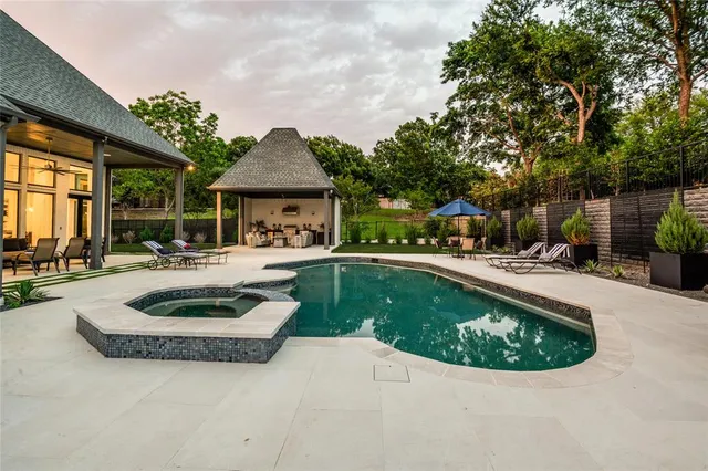 a view of a house with swimming pool and sitting area