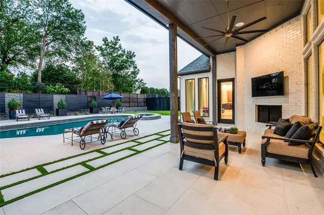 a living room with patio furniture and a fireplace