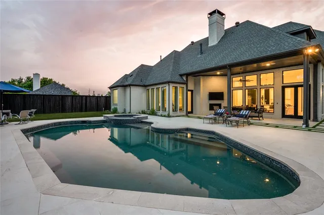 a swimming pool with outdoor seating and yard