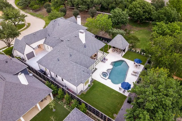 an aerial view of a house with a yard and lake view