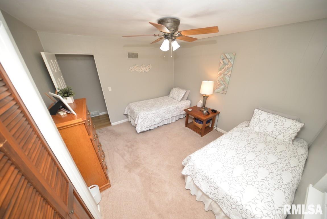 10 Edgewood Drive Mount Vernon, IL 62864 - Photo 24 of 41 a bedroom with a bed and a chandelier