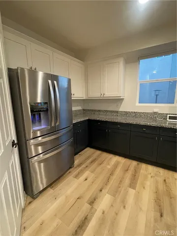 a kitchen with granite countertop sink and cabinets