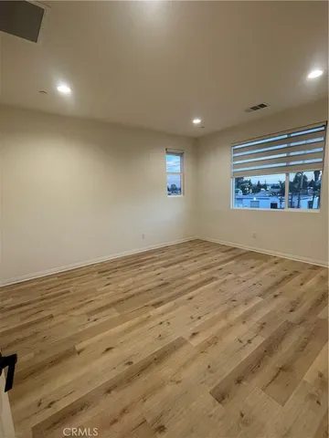 a view of a room with wooden floor