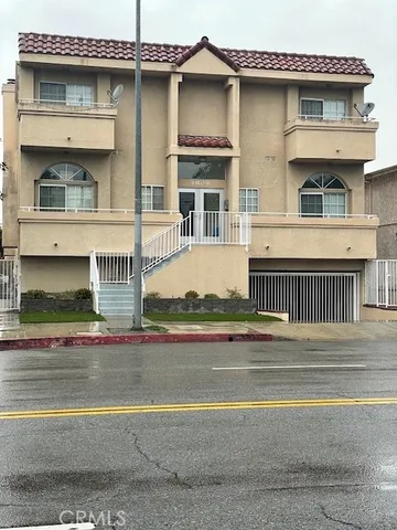 a front view of a house with a road