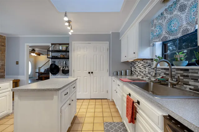 a kitchen with a sink stove and cabinets