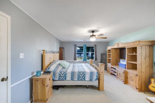 a bedroom with bed and window